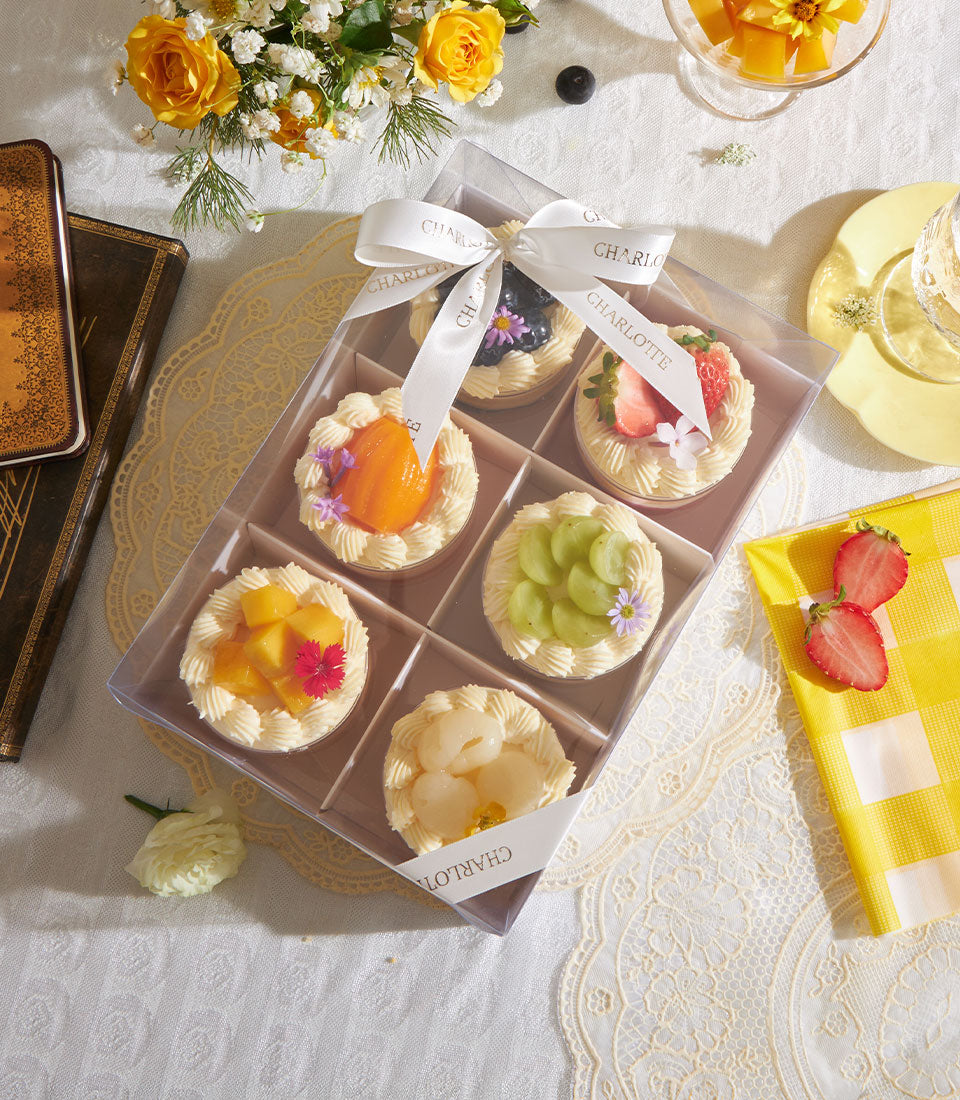 Six artisan fruit tarts with fresh cream and berries in elegant gift box by Charlotte Bakery