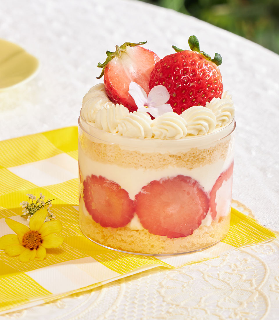 Summer mini chiffon cake with fresh strawberries and whipped cream in clear cup