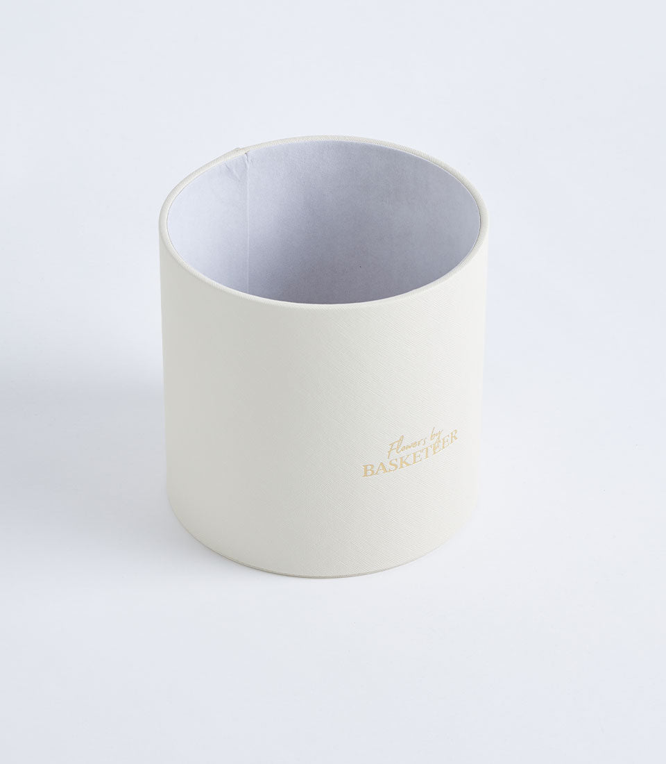 Luxurious round ivory textured gift box by Basketeer, perfect for a premium flower