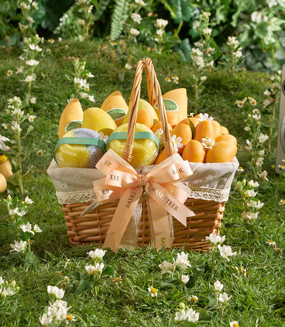 Premium Thai mango and sticky rice gift basket with woven wicker and peach ribbon bow