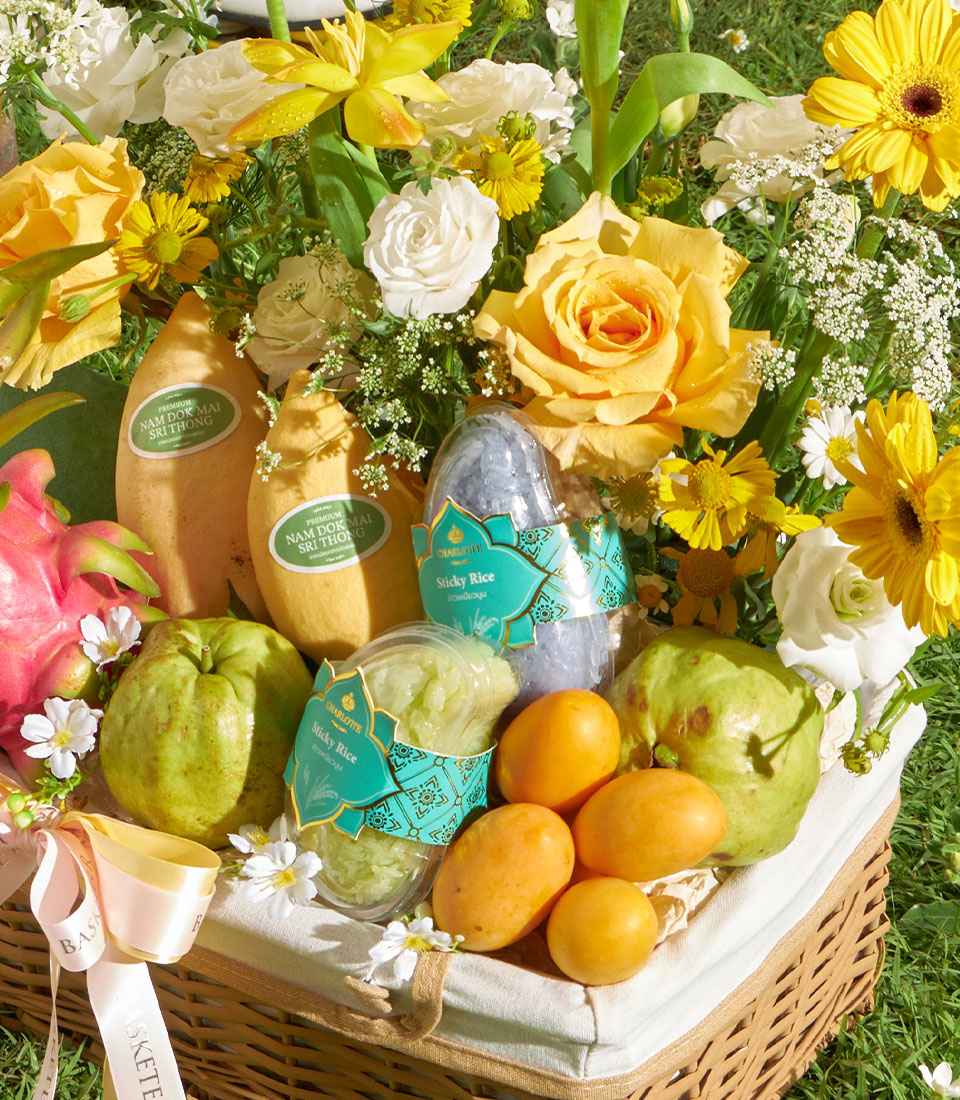 Tropical fruit gift basket with fresh mango, dragon fruit, and guava, paired with jasmine flowers and premium sticky rice