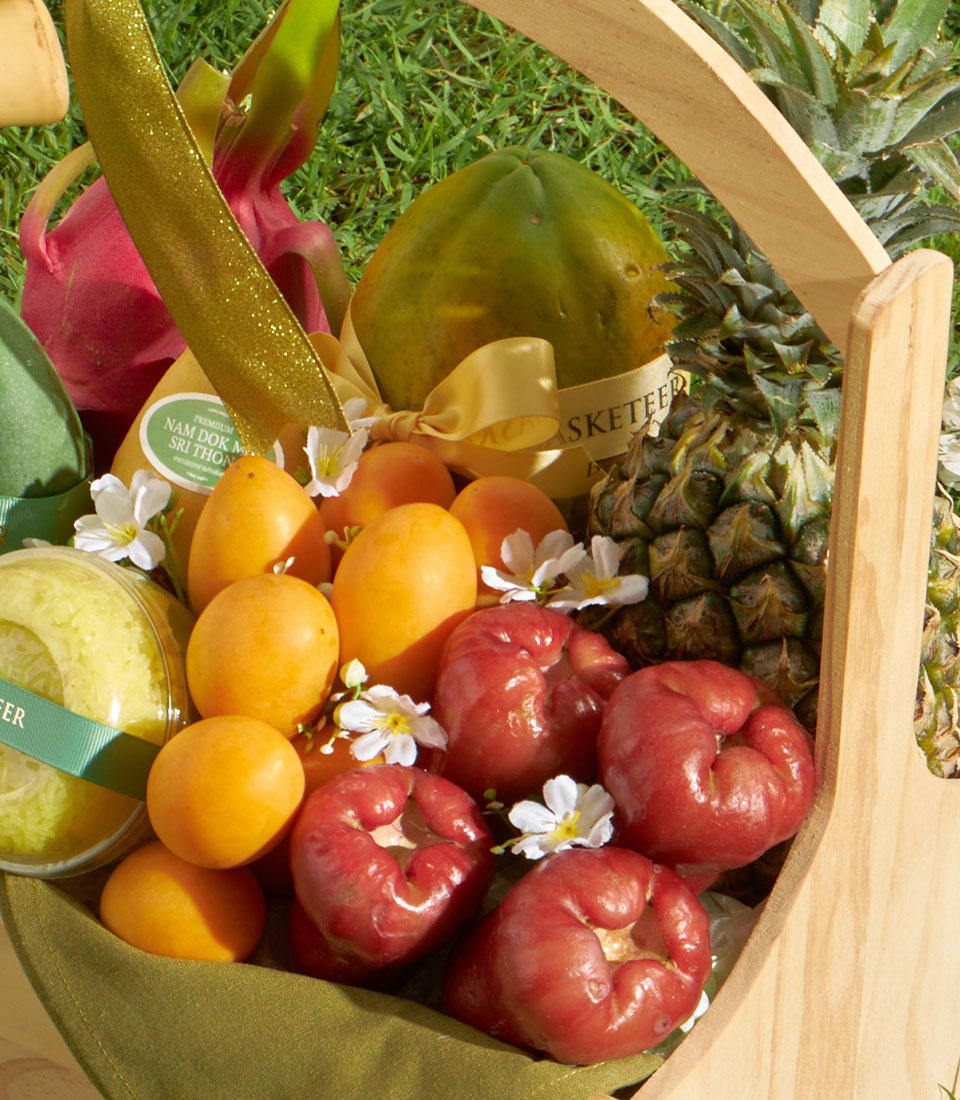 Premium tropical fruit gift basket with mango, pineapple, and fresh local fruits in wooden basket