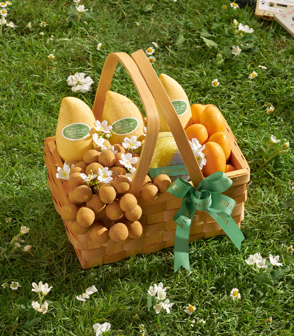 Premium longan and mango gift basket with white flowers and green ribbon