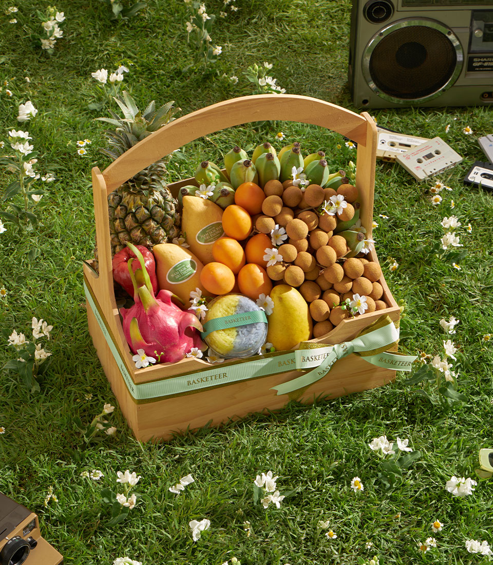 Premium Thai fruit basket with longan, mango, pineapple, and seasonal selection in woven wooden gift basket