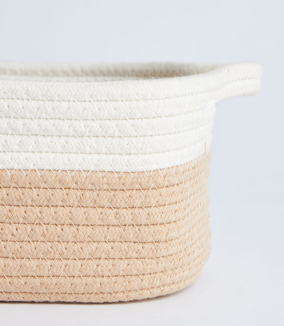 Beige and white coiled rope storage basket with integrated handles and lid