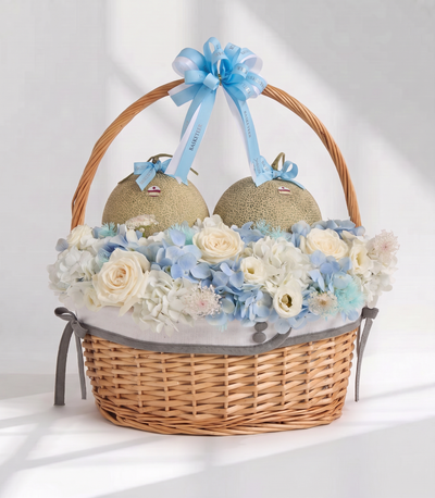 Basketeer luxury gift basket featuring two premium Japanese melons nestled among white roses
