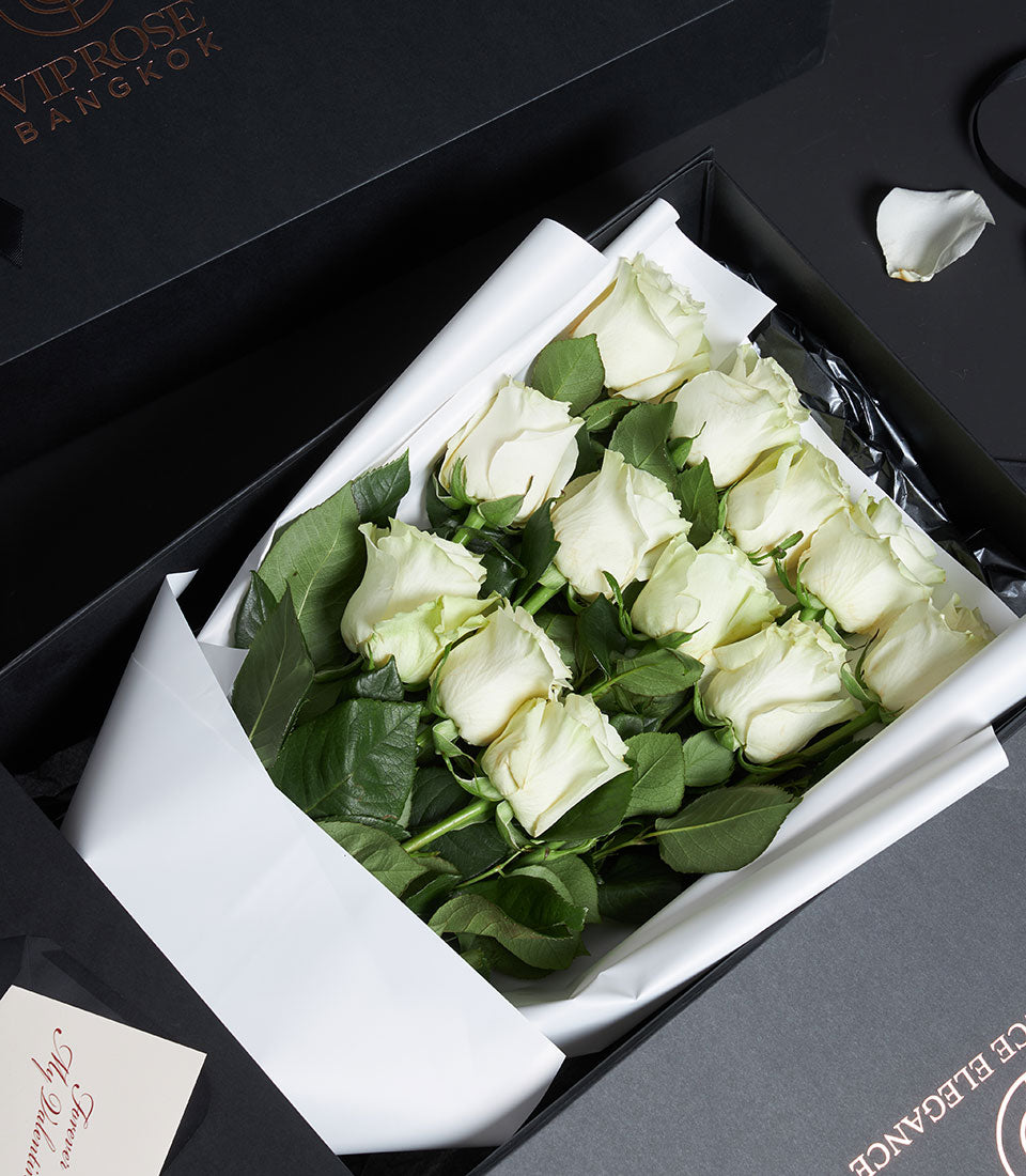 Luxury white rose bouquet in black gift box with gold accents, premium Valentine's Day flowers from Ecuador