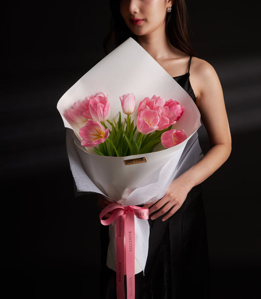 Premium pink tulip bouquet with white paper wrap and pink ribbon bow for Valentine's Day