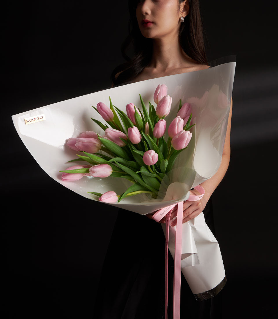 Pink tulip Valentine bouquet with white wrapping and ribbon