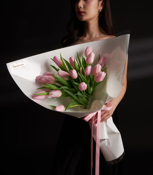 Pink tulip Valentine bouquet with white wrapping and ribbon