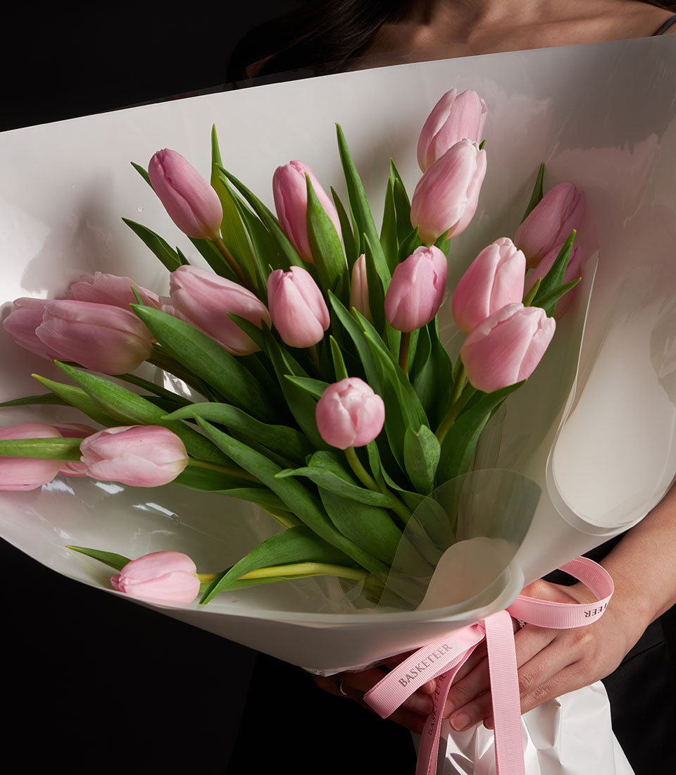 Premium pink tulip bouquet with white wrapping and pink ribbon for Valentine's Day