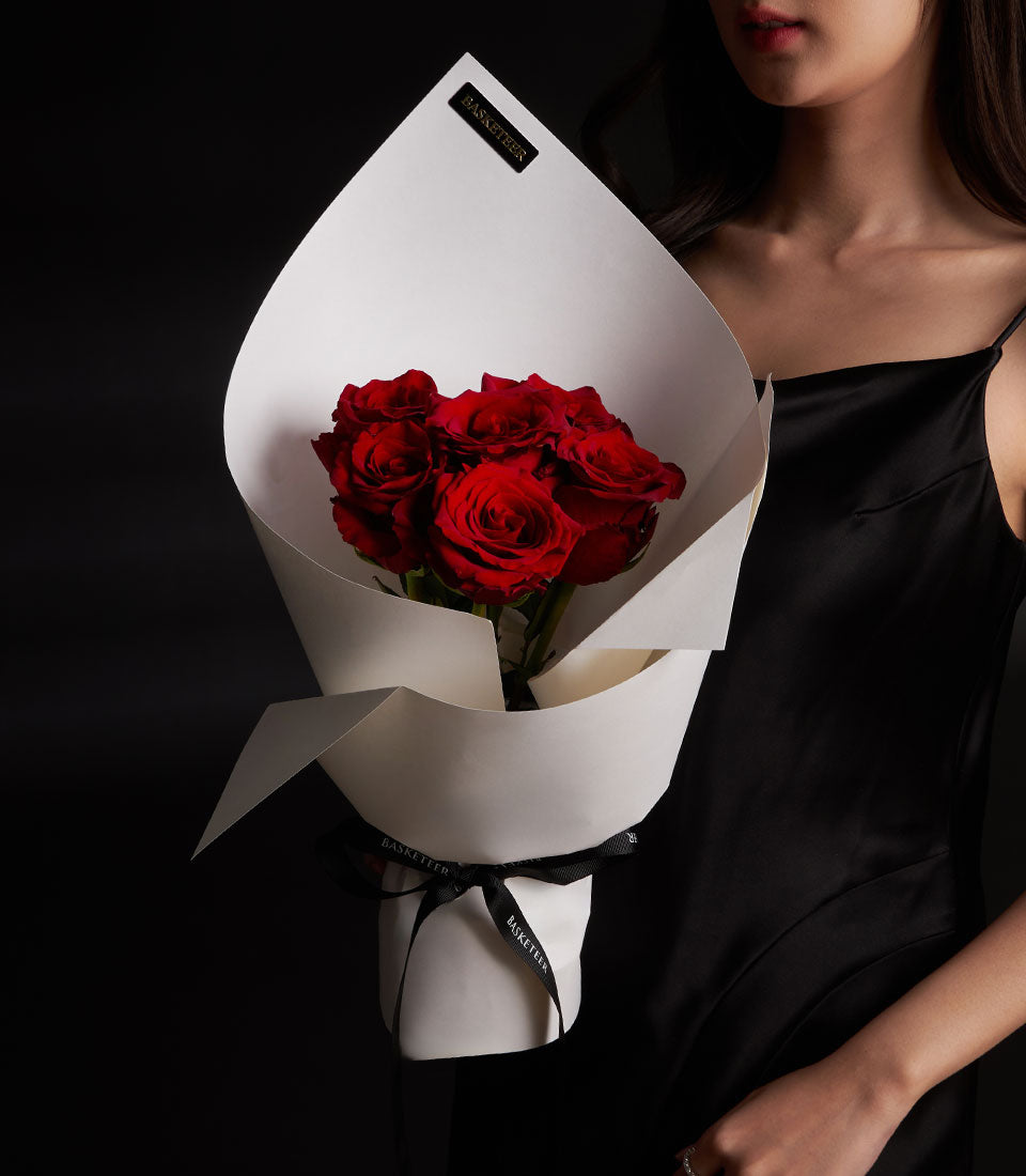 Vibrant red Ecuador roses bouquet in white paper wrap with black ribbon, Valentine's Day gift