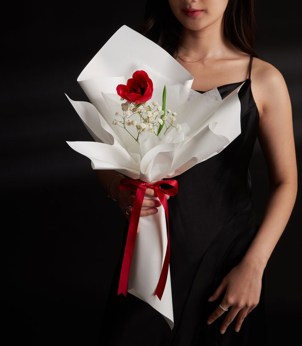 Red tulip and gypsophila bouquet with satin ribbon, perfect Valentine's Day flower gift