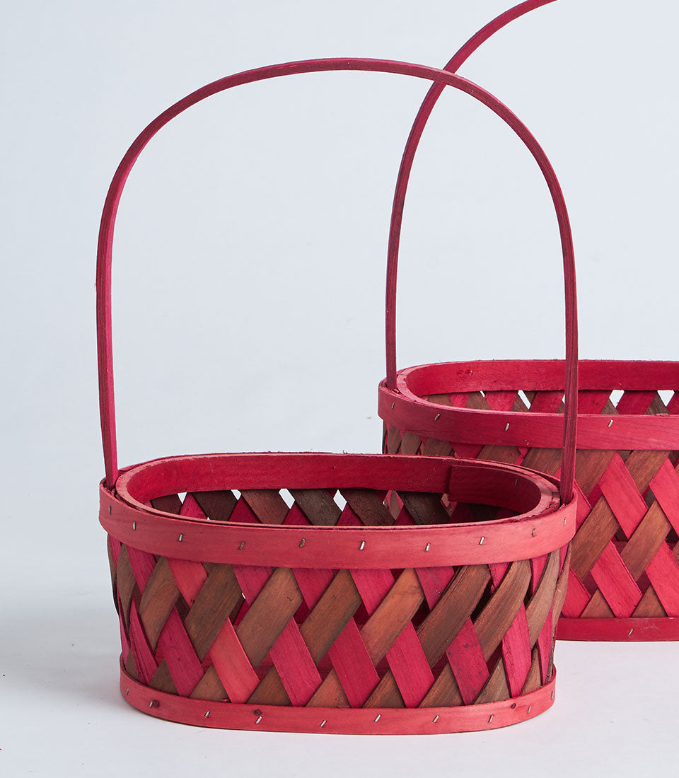 Red wooden woven basket with handle, natural and dyed wood weave in diagonal pattern