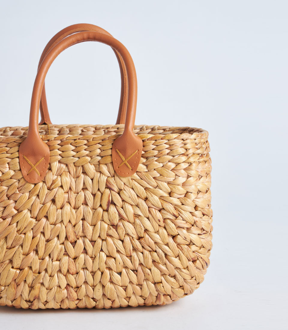 Natural woven straw basket with leather handles, light brown artisan tote for premium gifting