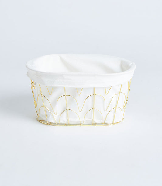 Oval gold metal wire basket with white fabric lining, artisan gift storage