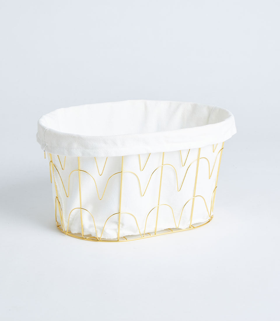 Gold metal wave-pattern basket with white fabric lining for luxury gift hampers