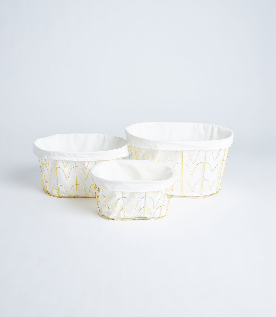 Gold metal wire storage baskets with white fabric liners, three sizes, modern arch design