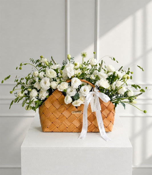 Elegant white eustoma and spray carnation arrangement with lush greenery in a