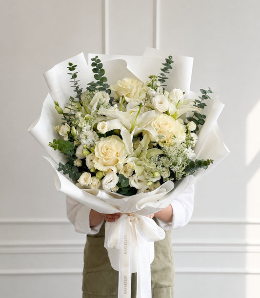 Elegant white rose and lily bouquet from Flowers by Basketeer, featuring fresh cream roses
