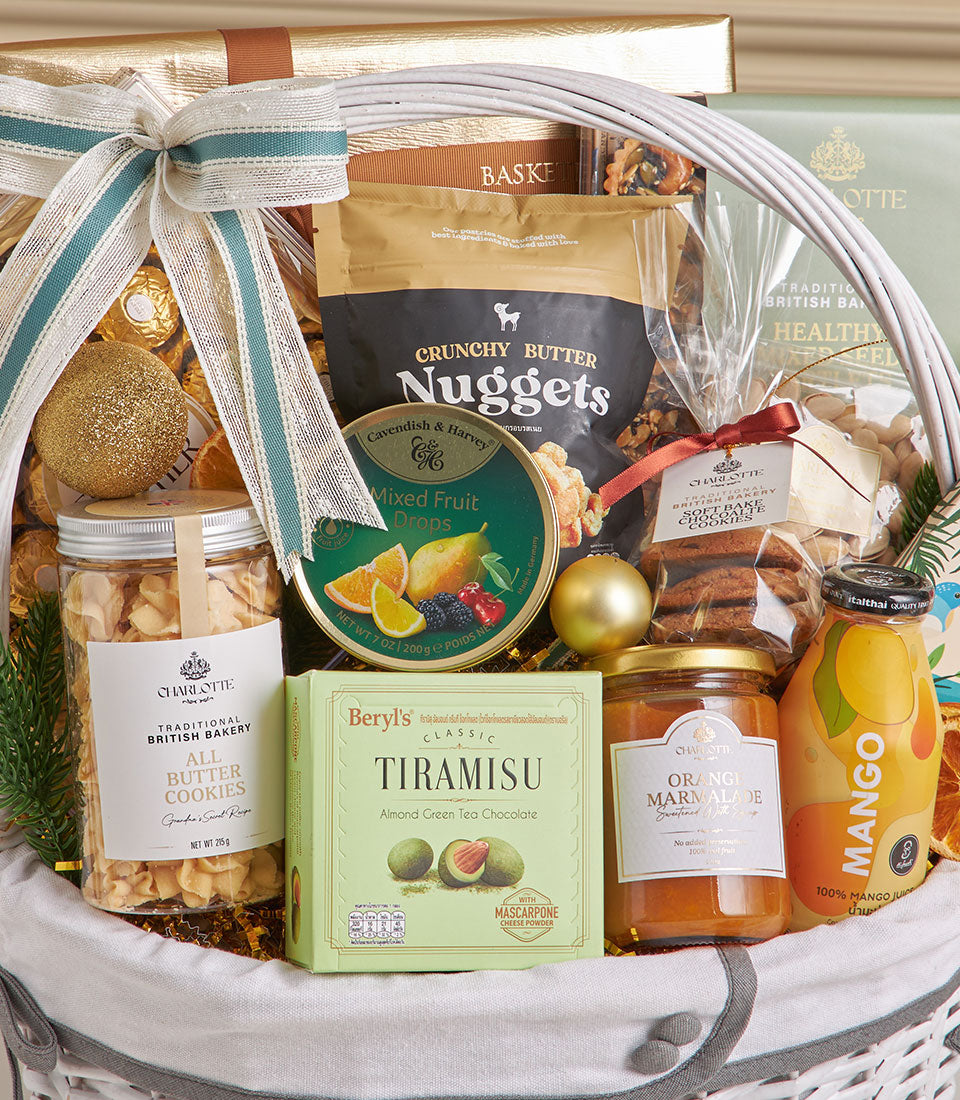 White woven New Year gift basket with teal striped ribbon bow, filled with gourmet coconut roll, chocolate cookies, mixed