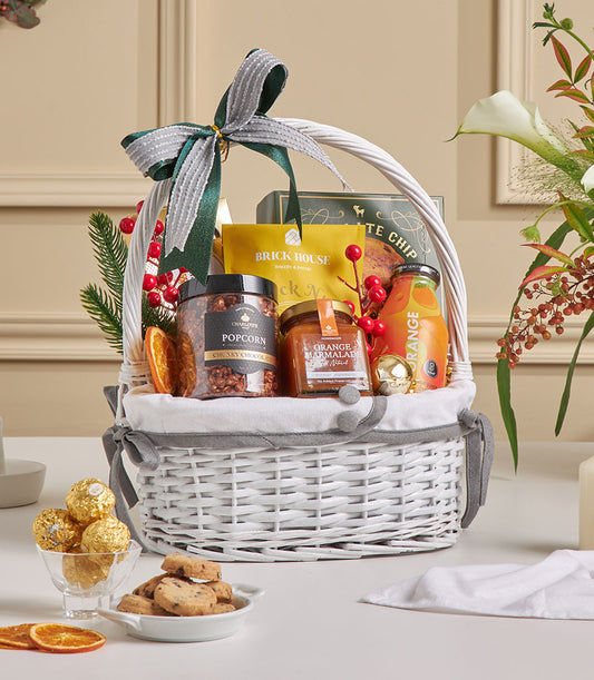Premium gourmet gift basket with chocolate chip cookies, popcorn and orange marmalade for New Year celebrations