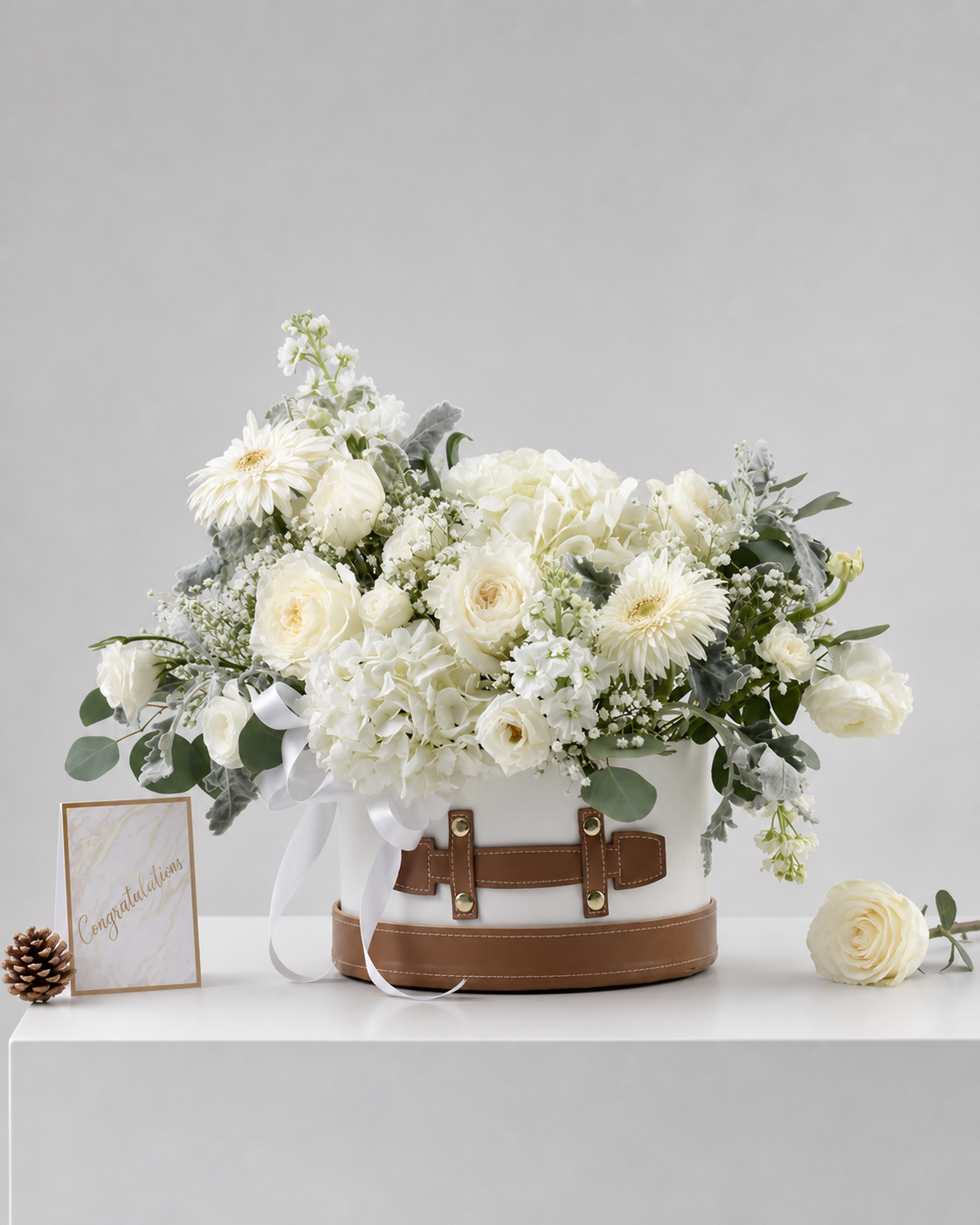 A luxurious white flower arrangement by Flowers by Basketeer, featuring fresh roses