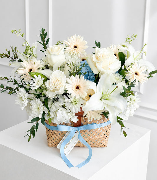 Luxurious basket arrangement by Flowers by Basketeer featuring white roses, lilies,