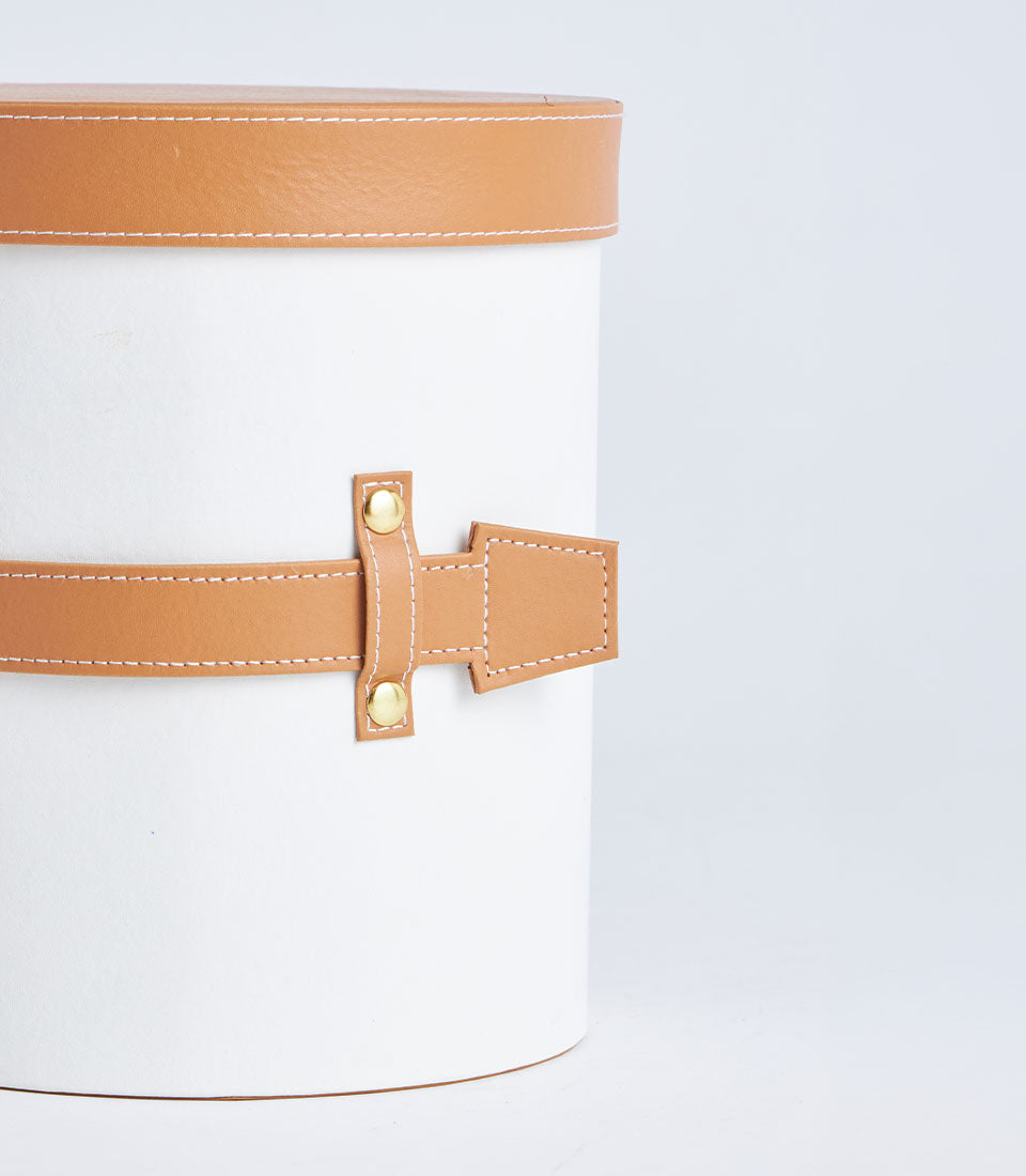 Basketeer's elegant white round gift box, featuring a tan