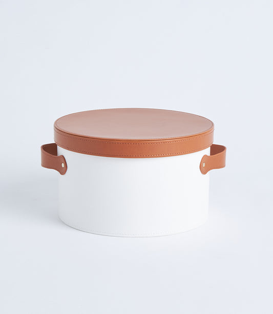 Round white hat box with tan leather lid and riveted handles, premium gift packaging