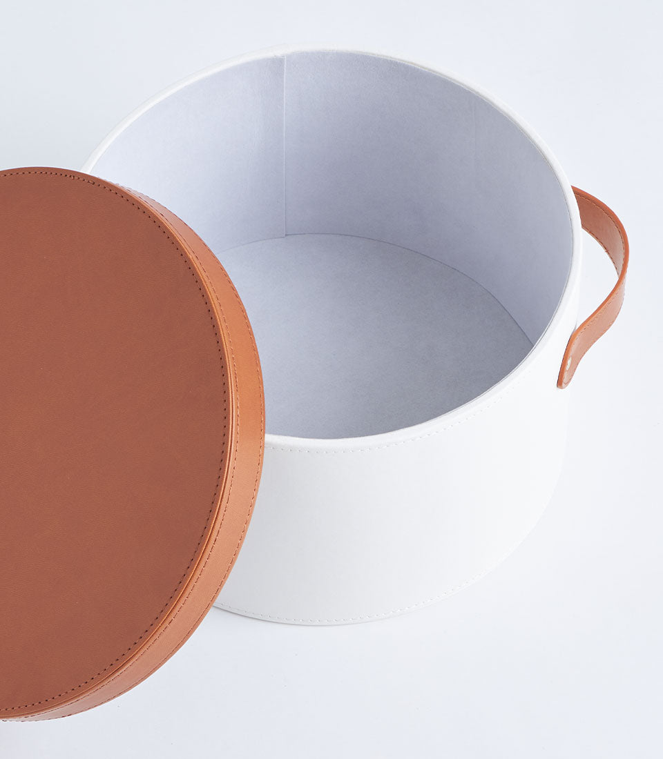 Basketeer's premium white round gift box with a luxurious brown leather lid