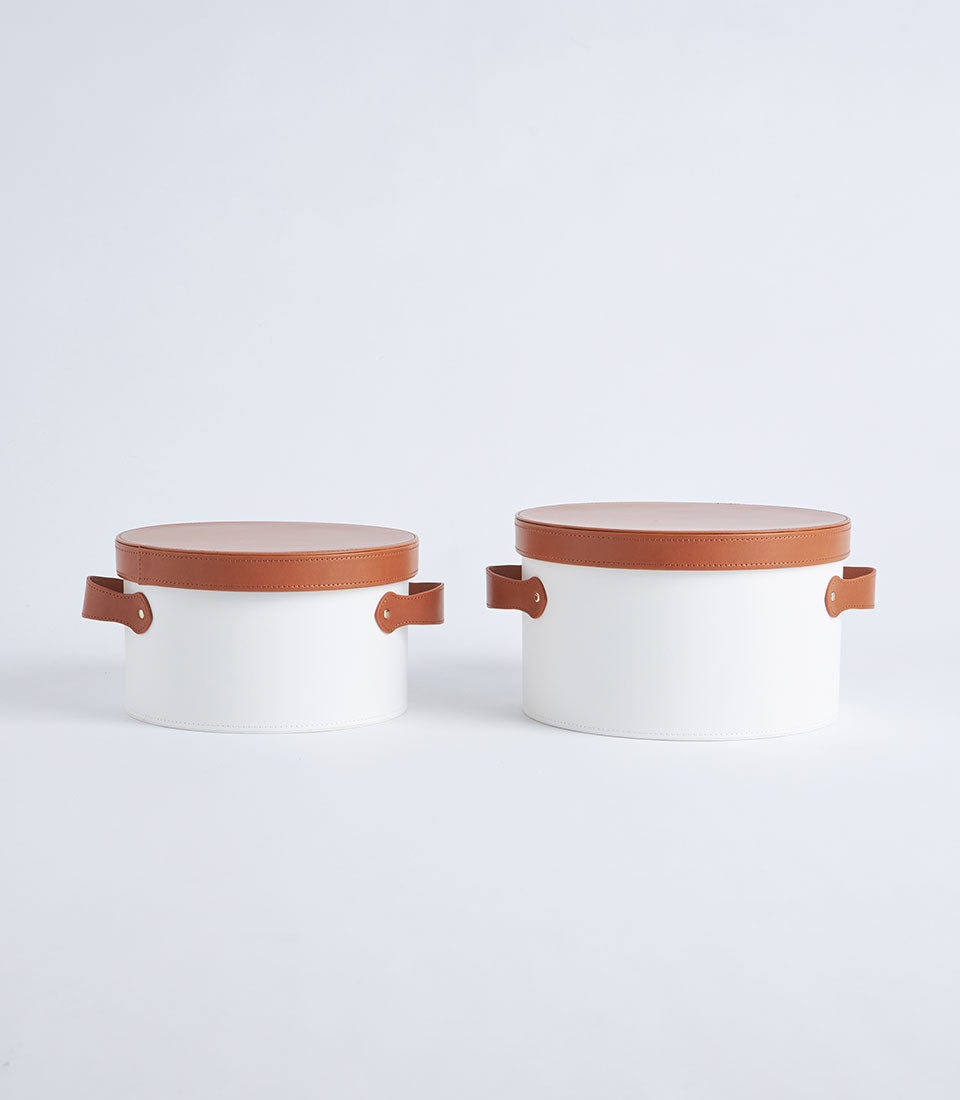 Basketeer premium corporate gift boxes: two round white boxes with luxurious tan leather