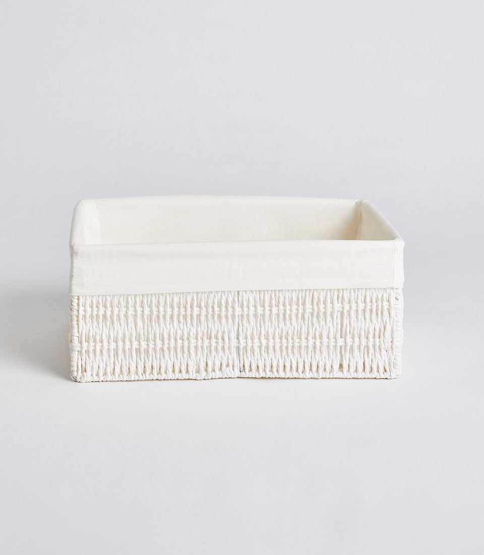 Handwoven rectangular wicker storage basket with cream fabric lining