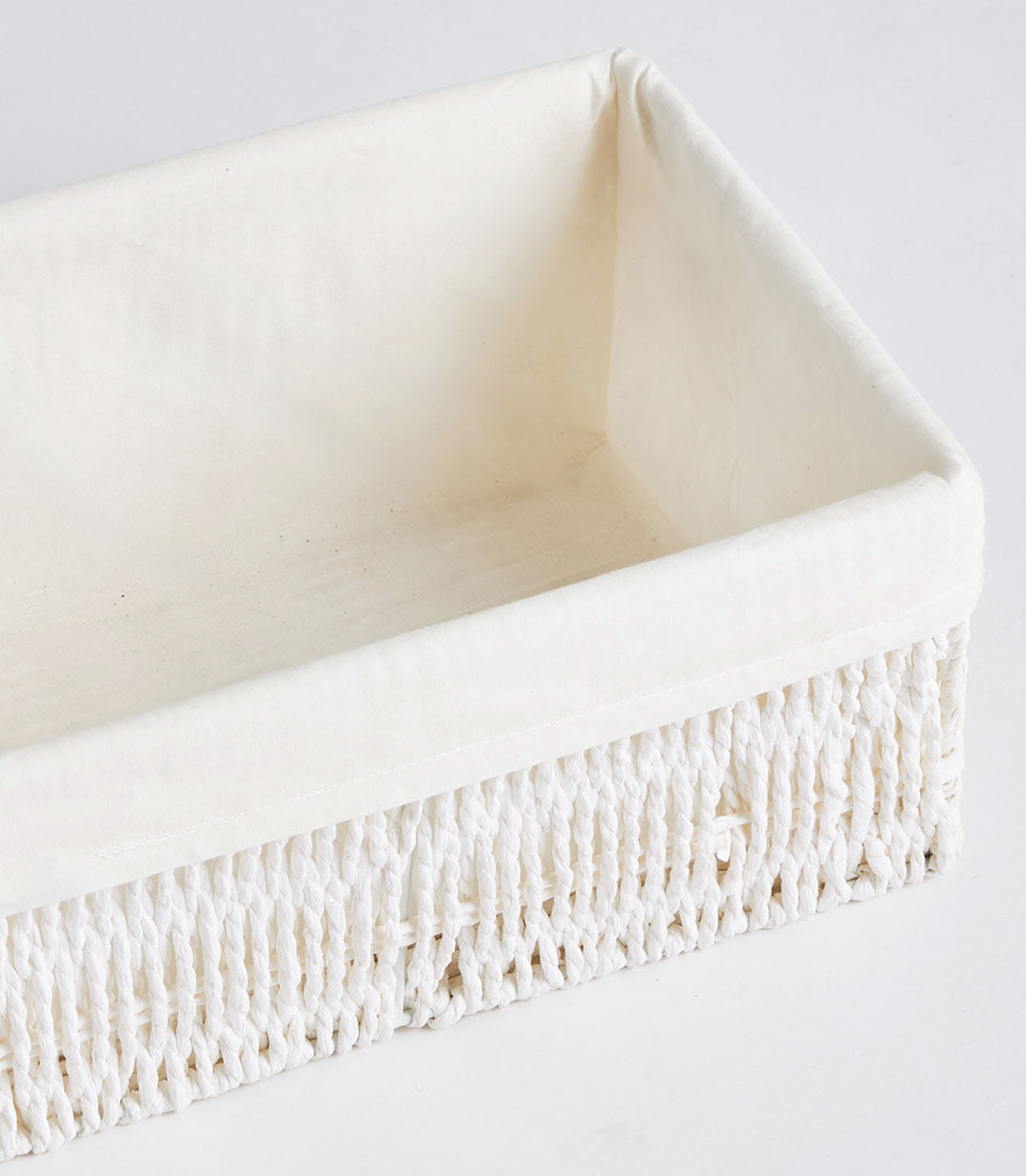 Handwoven rectangular wicker storage basket with cream fabric lining