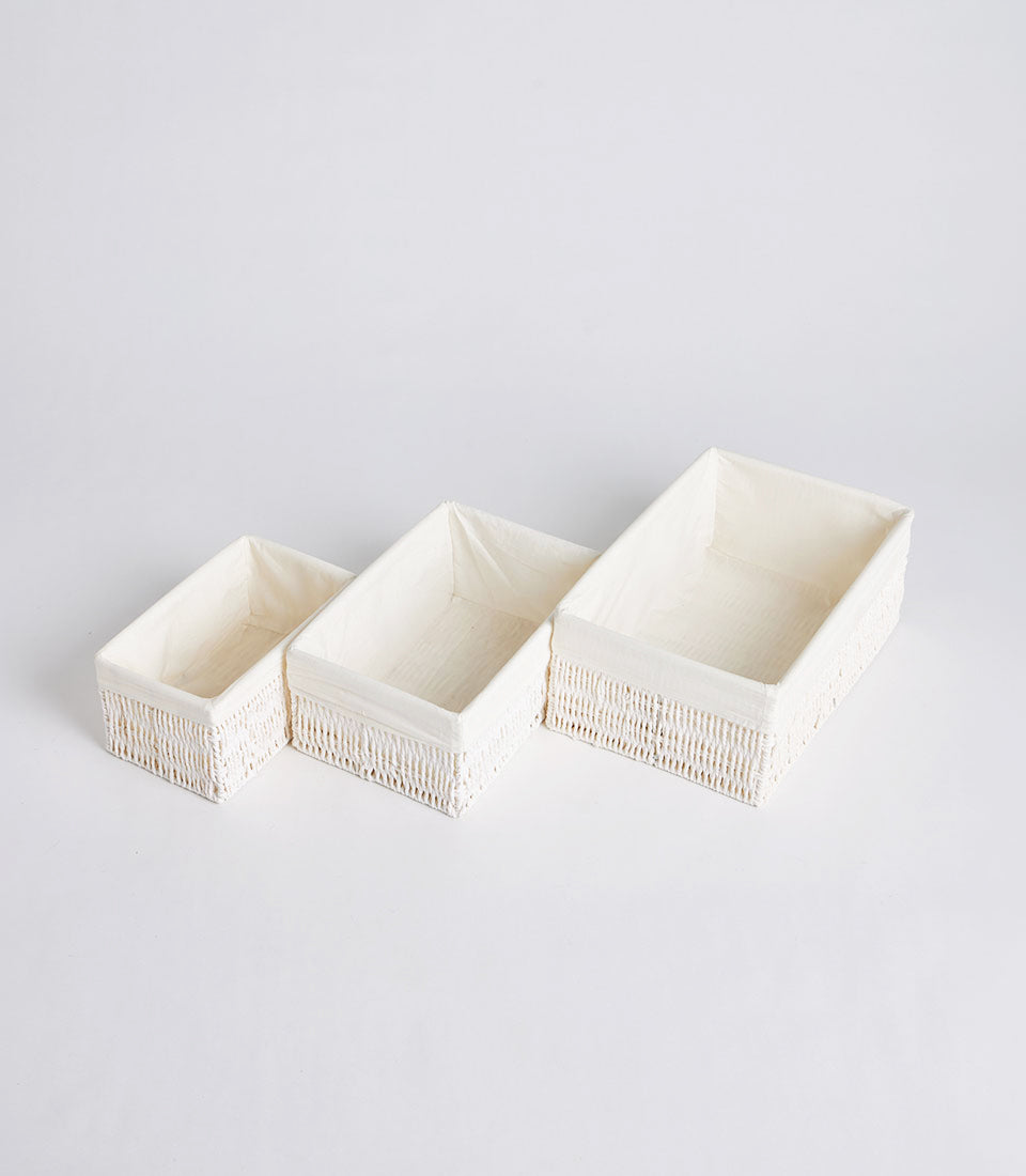 Handwoven rectangular storage baskets in natural cream with fabric-lined interiors, three sizes