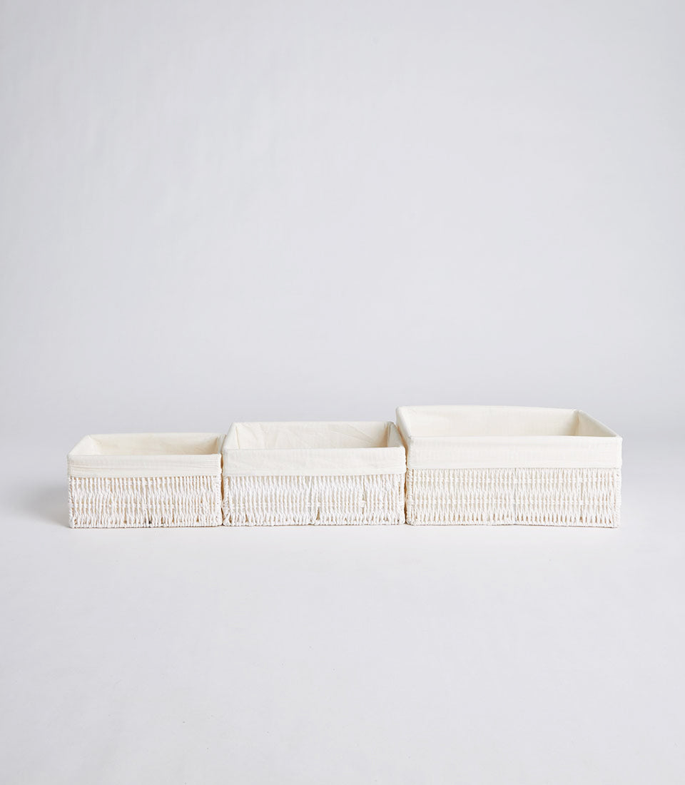 Handwoven rectangular wicker baskets with cream fabric liners, set of three nested storage containers