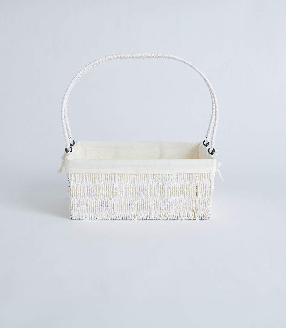 Natural woven wicker basket with cream fabric lining and arched handle