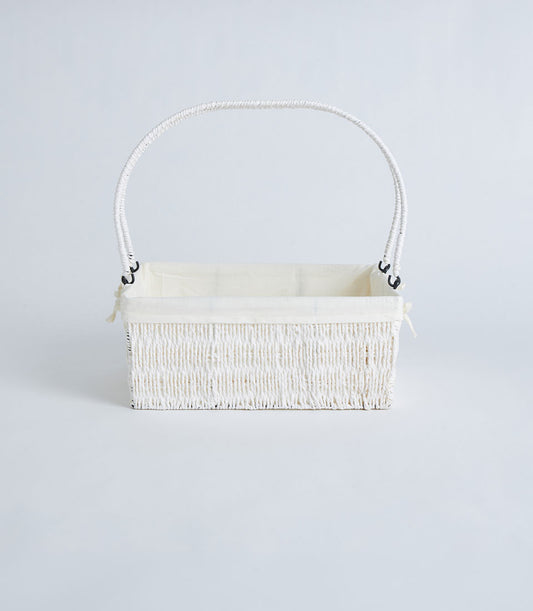 Natural woven wicker basket with cream fabric lining and arched handle