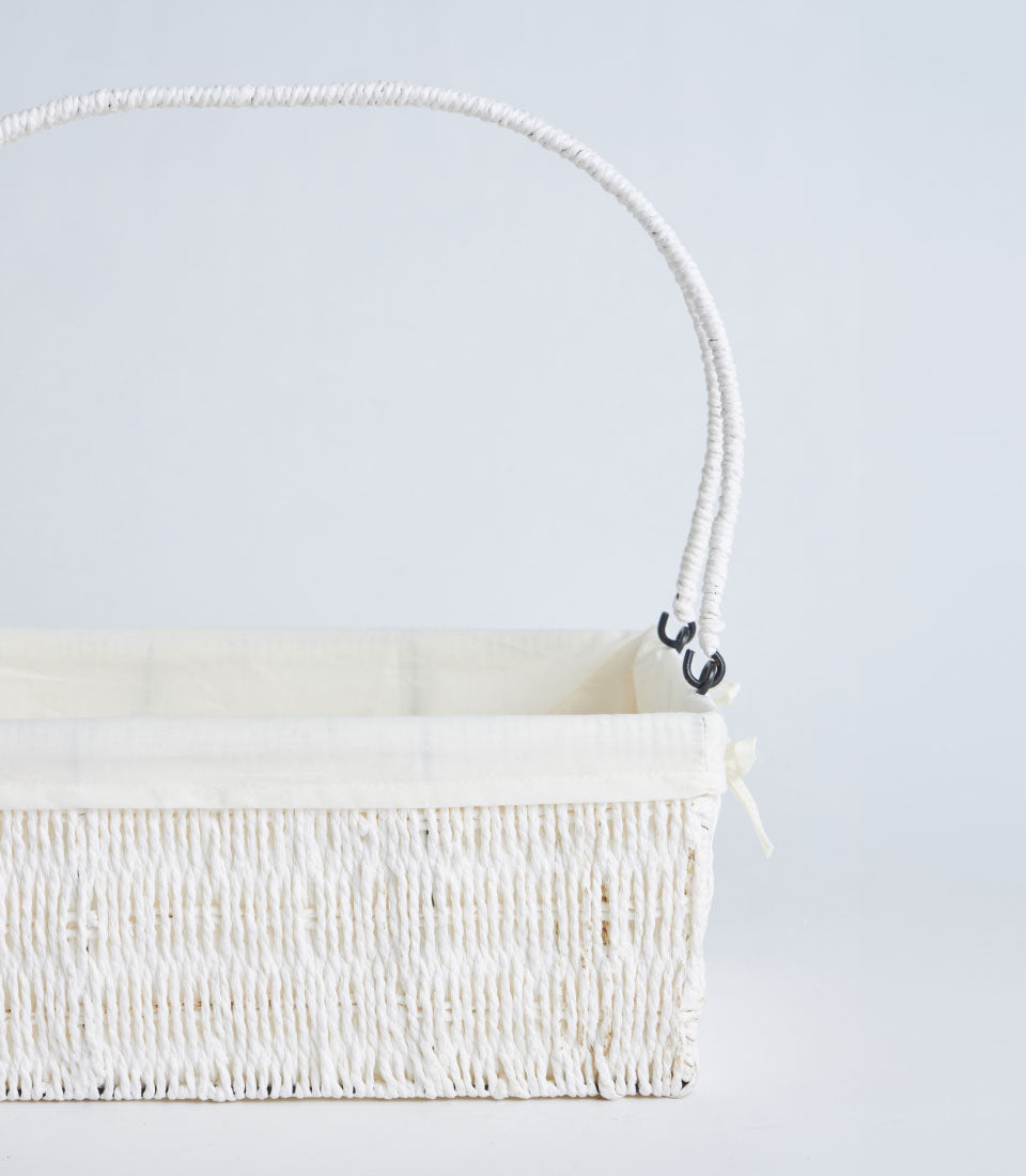 Natural woven white basket with cream fabric liner and twisted handle for premium gift presentation