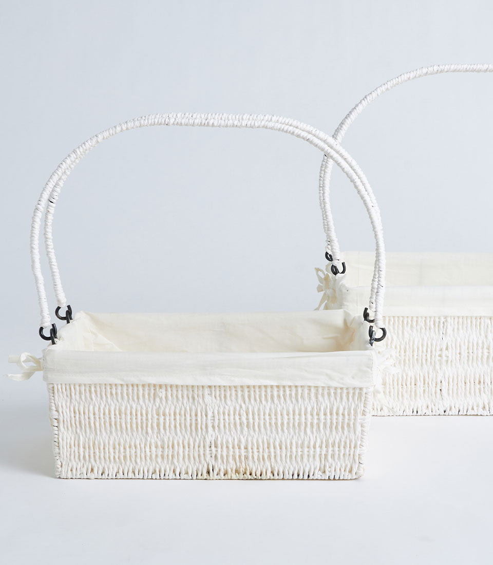 Natural wicker gift basket with cream fabric liner and arched handle