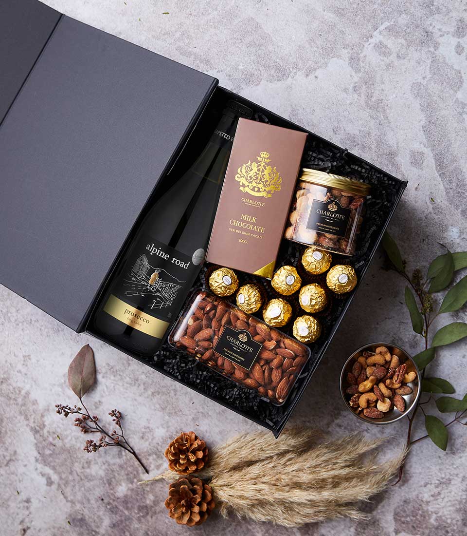 Luxury wine and chocolate gift set with Alpine Road Prosecco, artisan chocolates, and gourmet nuts in premium black gift box