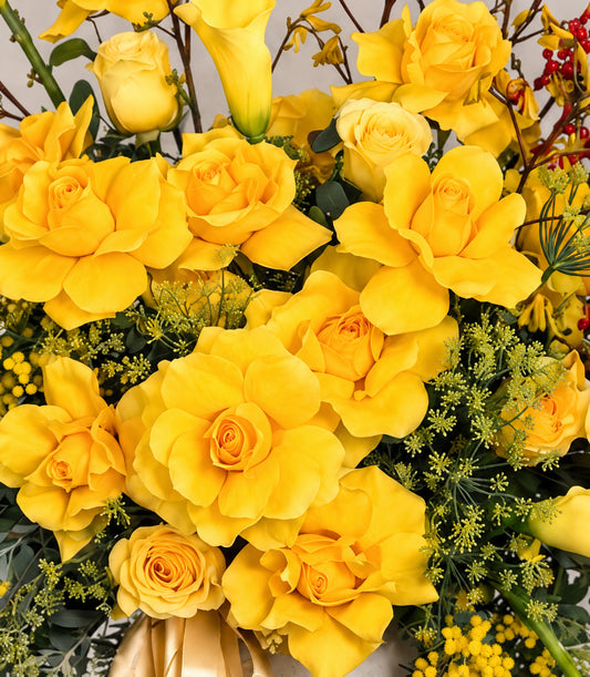 Close-up of Brighton roses and yellow calla lilies in the Golden Radiance vase arrangement