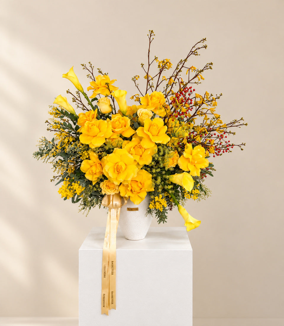 Wide studio view of Golden Radiance yellow flower vase with golden Basketeer ribbons