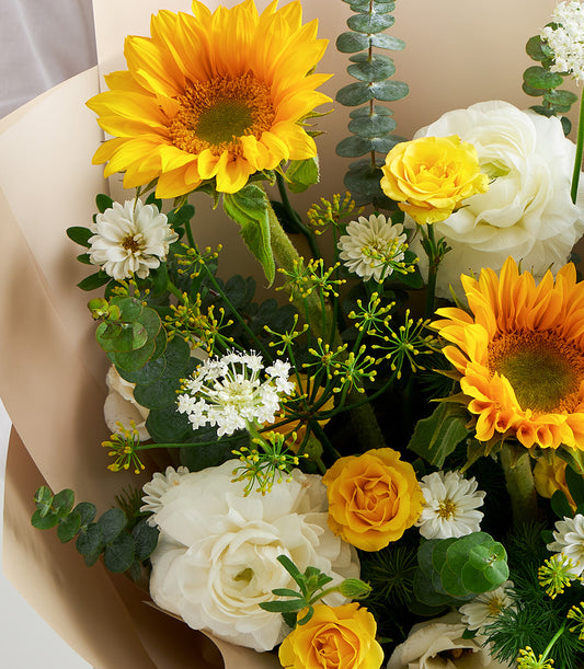 A vibrant Sunshine Cheer premium flower bouquet from Flowers by Basketeer, featuring