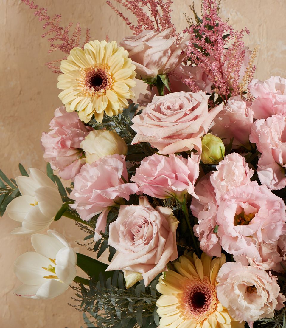 Pastel Grace vase arrangement with pink roses, eustoma, yellow gerberas, white tulips, and astilbe